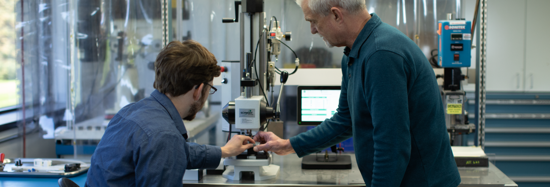 Two men discuss manufacturing development