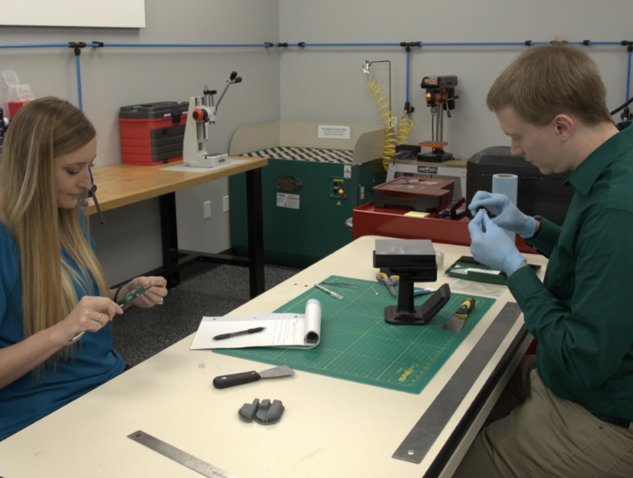 Man and woman working on products