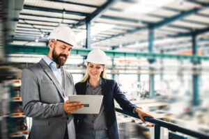 Manufacturing workers overseeing the plastic injection molding process