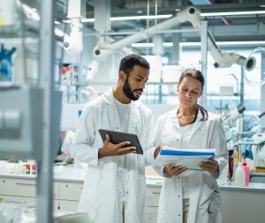 A close-up image of a scientist dressed for a clean room ensuring quality control of medical devices
