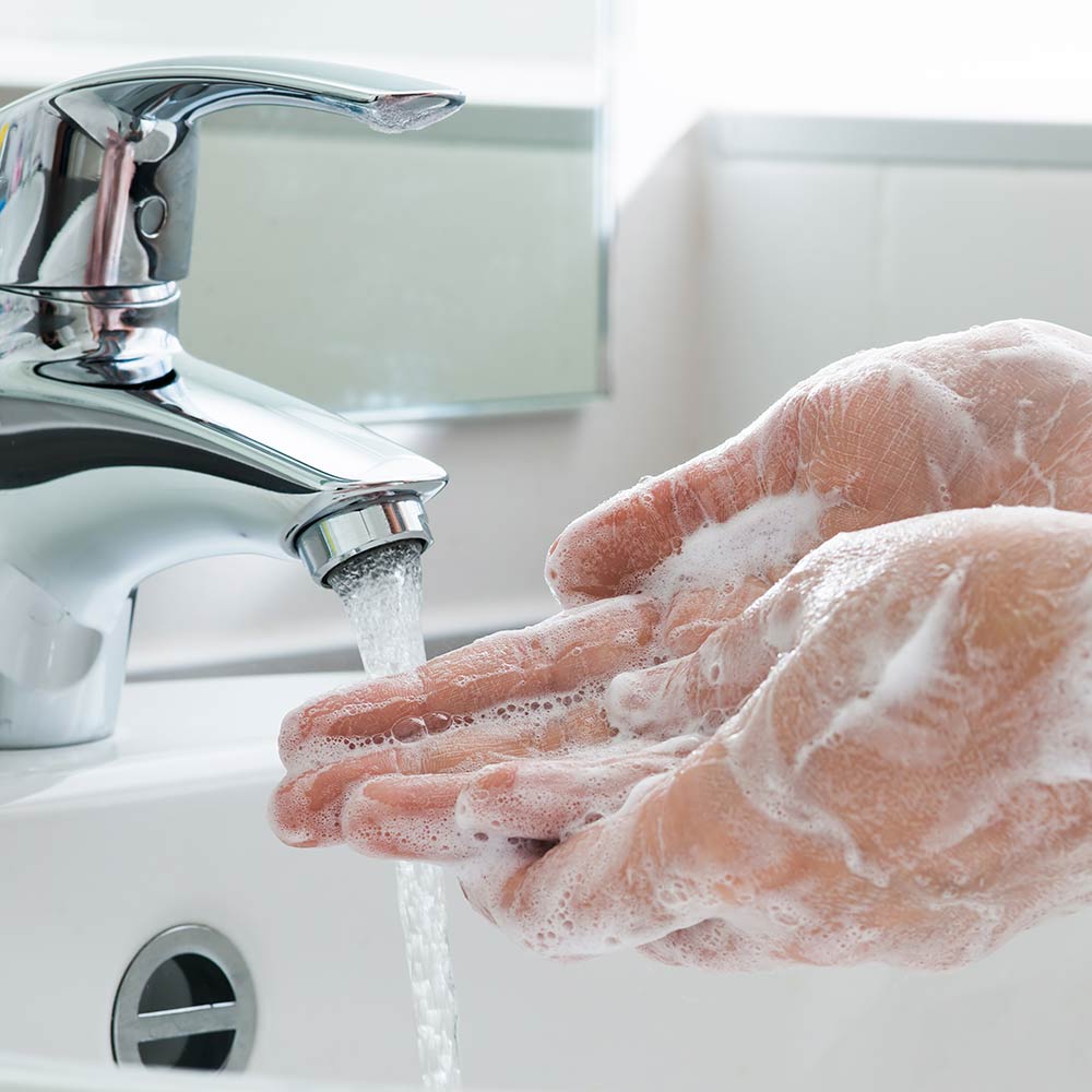 person washing hands with soap