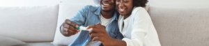 man and woman looking at pregancy test