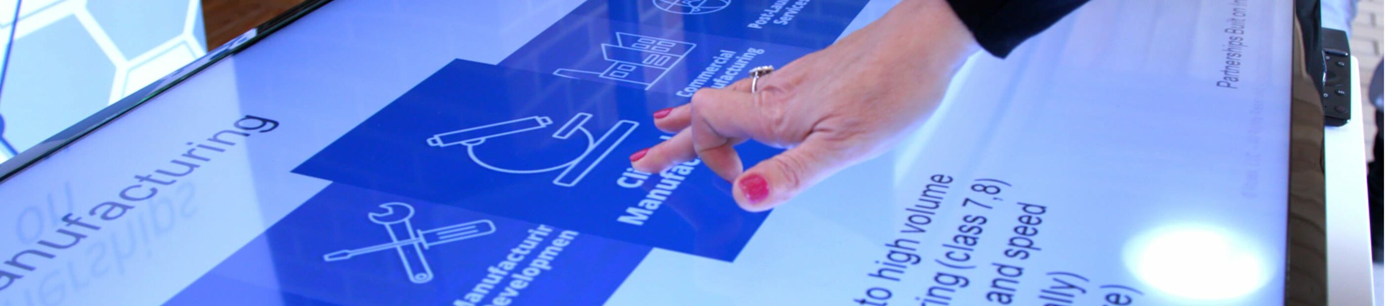 woman's hand interacting with data on a touch screen