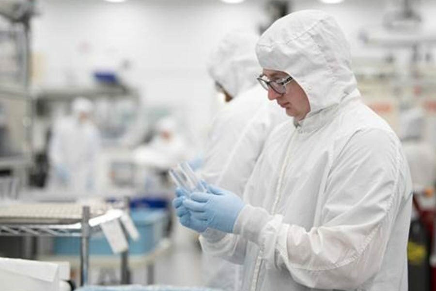 lab techs wearing lab coats in a lab