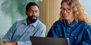 Two coworkers looking at a computer